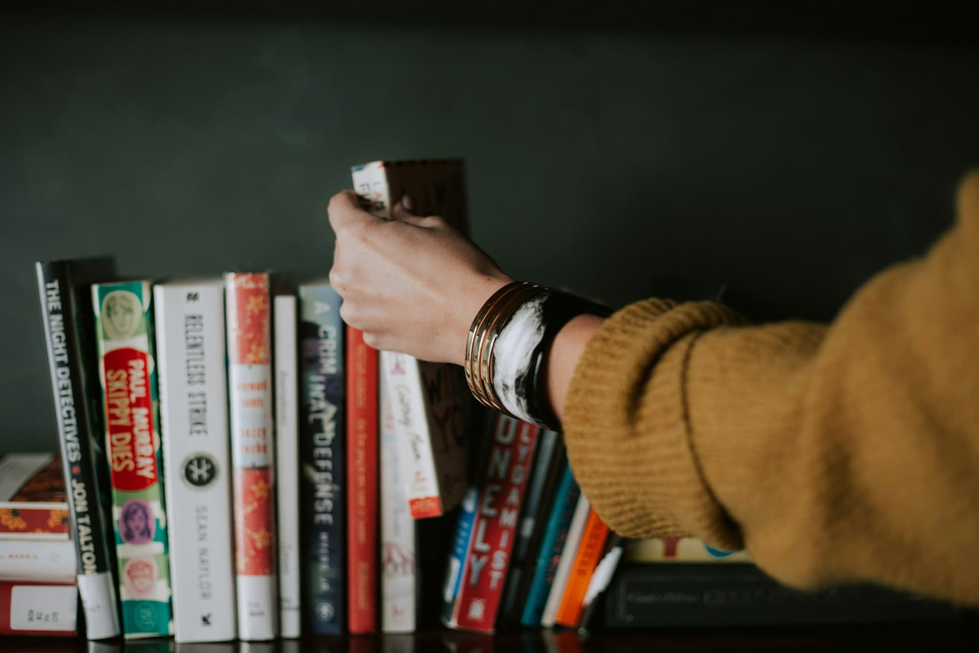 A hand reaching for a book, a quiet cultural moment