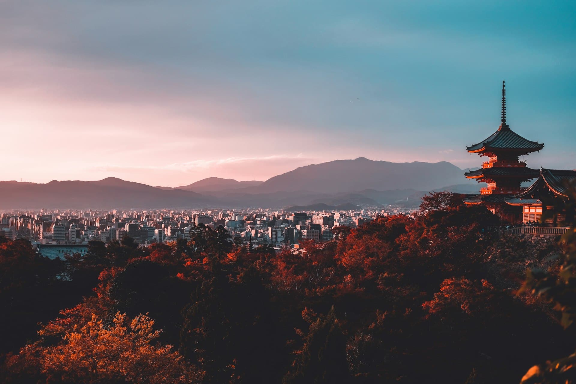 Kyoto rooftops and a pagoda silhouette at dusk